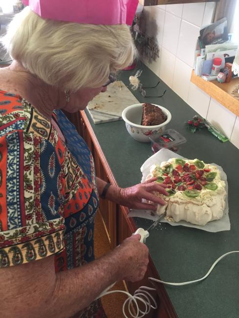 Auntie Doreen wielding the electric knife on her AMAZING pavlova!